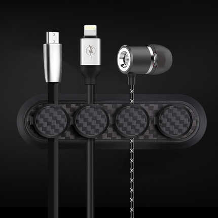 Carbon fiber magnetic cable organizer with usb, lightning, and earphone ports, neatly organizing cables on a sleek black desk...