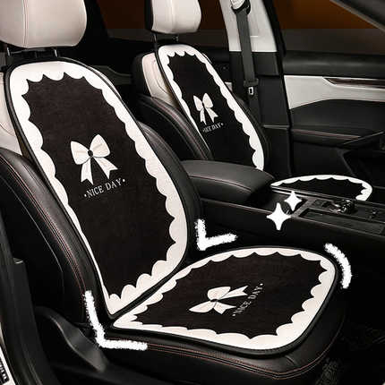 Black and white plush car seat cushion with a bow design, labeled nice day, providing warmth and comfort for winter use.