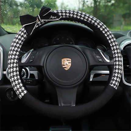 Elegant houndstooth-patterned steering wheel cover with a bow, crafted from cotton for all-season comfort in a porsche vehicl...