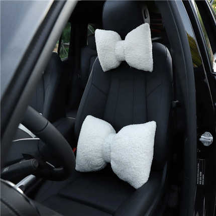 Lamb wool car headrest pillow: soft, plush diy neck support with bow design, enhancing comfort in black leather car seats.