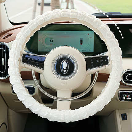 White goddess puff steering wheel cover with non-slip, sweat-absorbent design, enhancing grip and comfort in a modern car int...