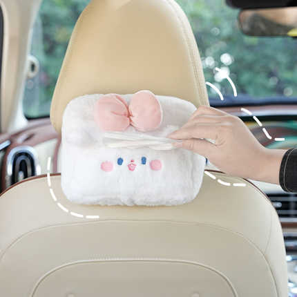 Cute plush cartoon car tissue box with a smiling face and pink ears, designed as a hanging armrest holder for easy access in ...