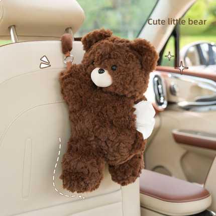 Cute plush bear car tissue box holder hangs on seat back, featuring soft brown fur and a white belly for stylish in-car stora...