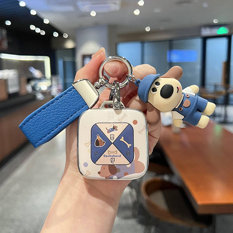 A hand holds a zeekr 001 smart key shell case featuring a cute dachshund design with a blue strap and a matching dog-shaped k...