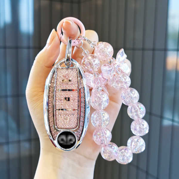 Elegant infiniti q50l key cover with a sparkling pink leather protector and decorative beaded charm, perfect for stylish car ...