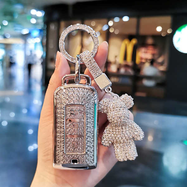 Elegant mitsubishi outlander key cover adorned with sparkling crystals, featuring a teddy bear charm and a sleek design for a...