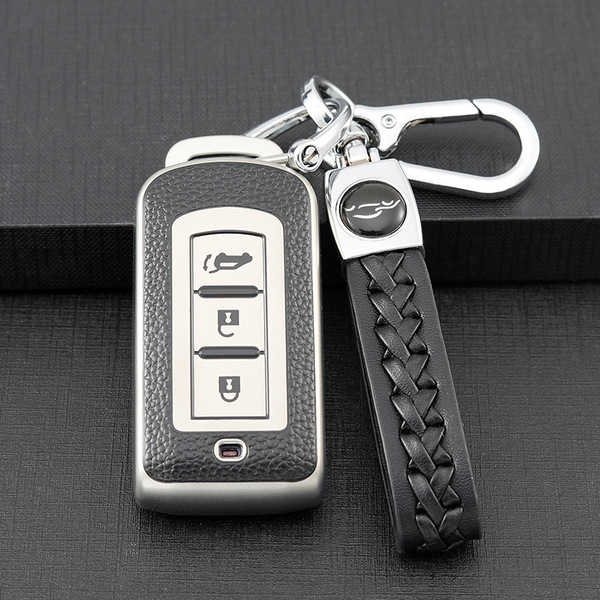 Elegant mitsubishi key cover for outlander, eclipse cross & pajero, featuring a sleek leather design and matching braided str...