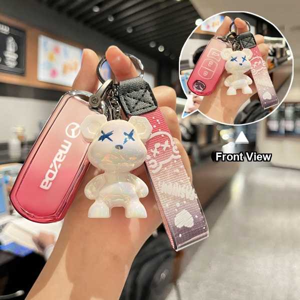 Front view of a mazda key cover for cx-3/cx-5/cx-9 & mazda3/mazda6, featuring a pink design with a cute bear charm and decora...