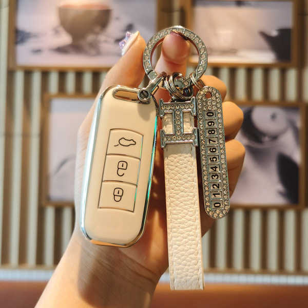 Elegant gac trumpchi gs4 key cover with a sleek design, featuring a leather strap and decorative keychain, perfect for gs3/gs...