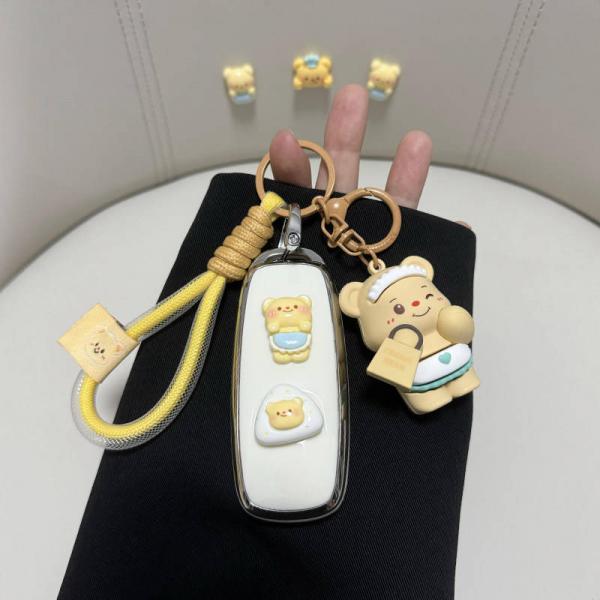 Adorable gac aion y key cover featuring cute bear designs and a playful keychain, perfect for eco-friendly car owners.