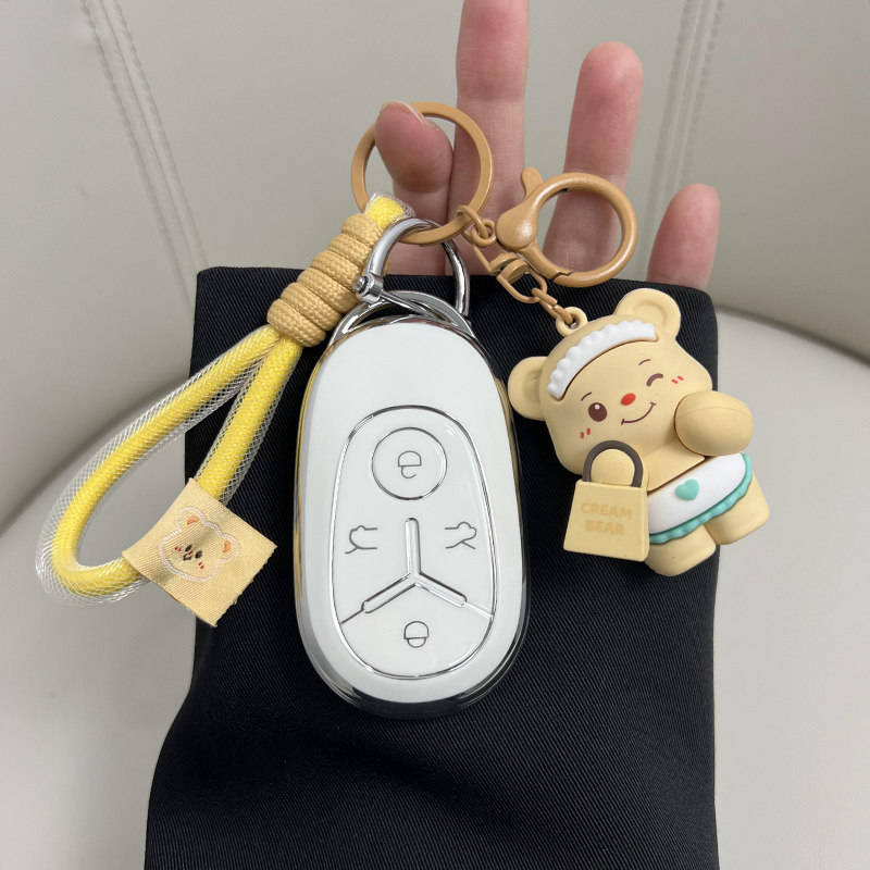 Geely starry wish 2025 key cover in a stylish pink shell case, featuring a cute teddy bear keychain and yellow rope strap for...
