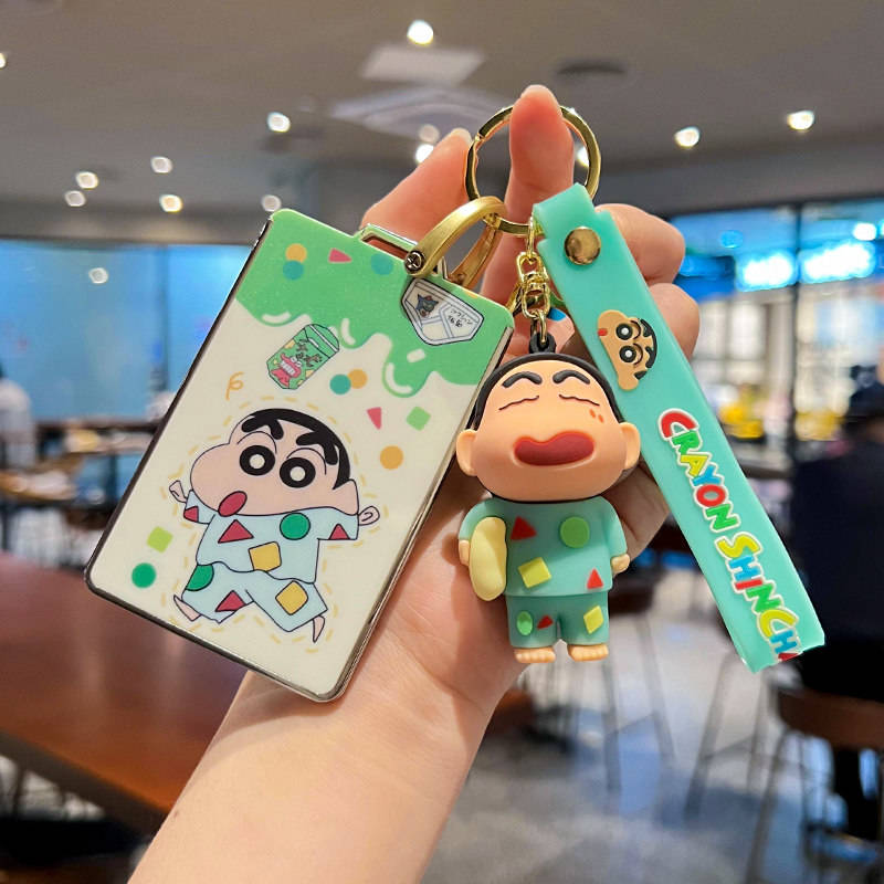 Hand holding a xiaomi su7 car key cover featuring a colorful cartoon design with a plush keychain and a vibrant strap, perfec...