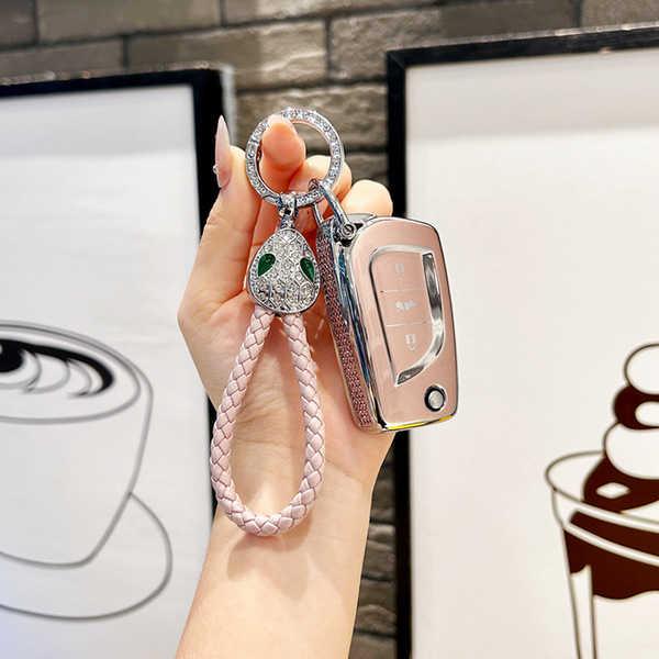 Elegant toyota fold key cover for camry, corolla & rav4, featuring a luxurious pink braided strap and a decorative snake pend...