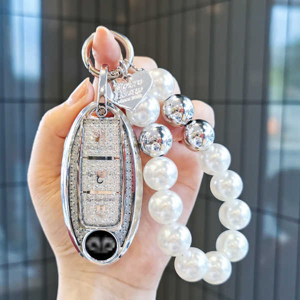 Elegant infiniti q50l key cover with sparkling rhinestones and pearl accents, offering stylish protection for your car keys.