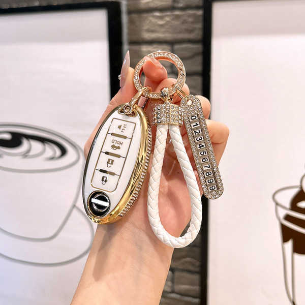 Elegant nissan qashqai key cover for 14th-gen models, featuring a gold-accented design with a white braided rope and diamond-...