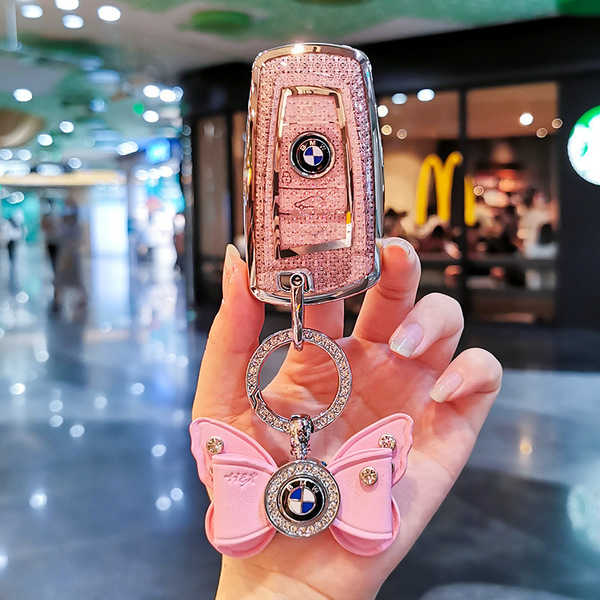 Elegant pink bmw key cover for 5 series 530 and 3 series 320li, featuring a butterfly charm and sparkling design.