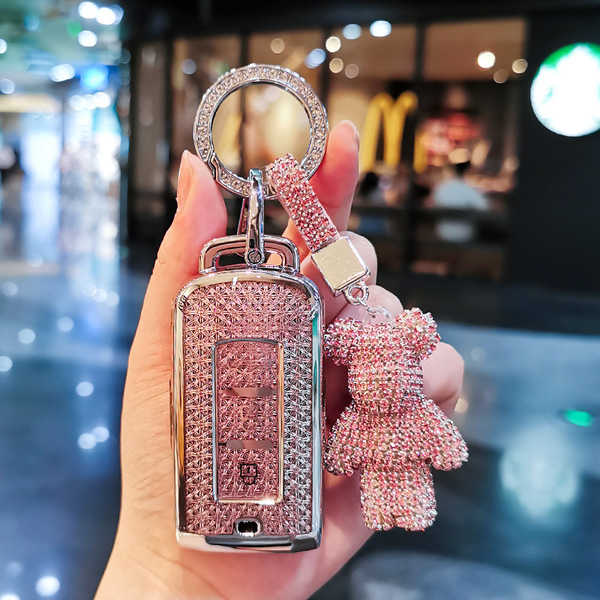 Elegant mitsubishi outlander key cover with sparkling rhinestone design, featuring a cute bear charm and a stylish ring for e...