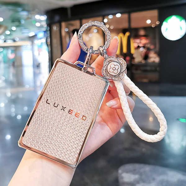 A hand holds a stylish luxeed nfc card key cover, featuring a textured design and a braided white strap, perfect for the huaw...