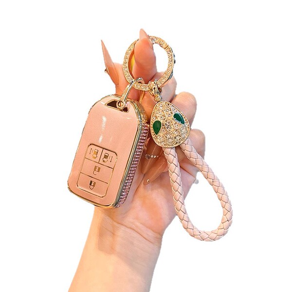 Elegant pink honda key cover for cr-v, accord, hr-v & civic, featuring a gold-accented design and decorative snake charm with...