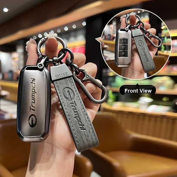 Hand holding a gac trumpchi key cover with leather strap, showcasing front view and sleek design for models gs4, gs5, gs3, gs...