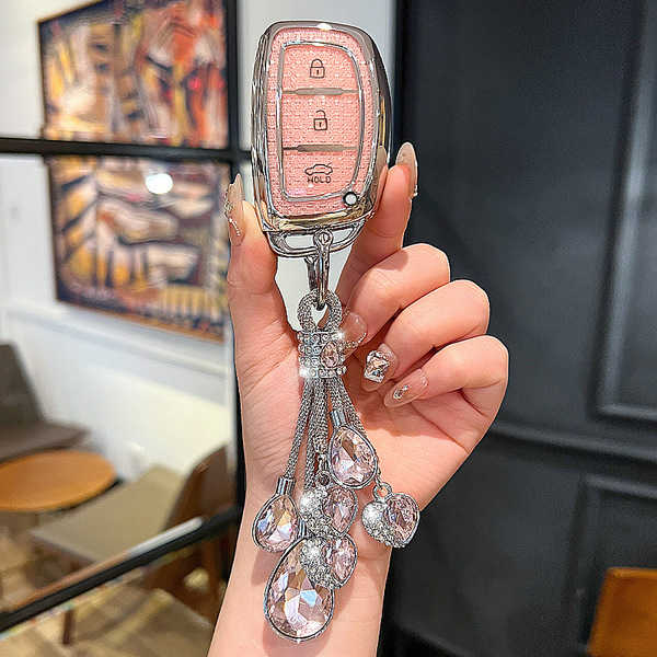 Elegant hyundai key cover for ix35, elantra, sonata, and more, featuring a pink design with sparkling crystal embellishments.