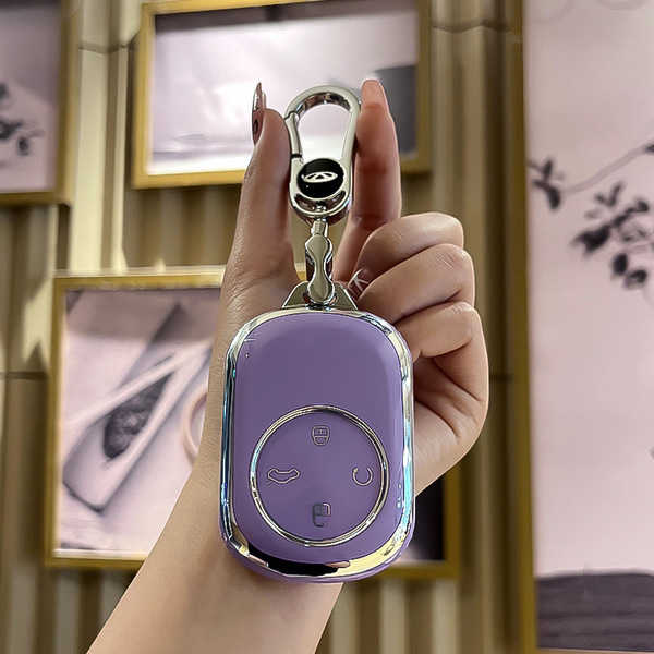 A hand holds a sleek, purple chery fengyun t9 key cover with a metallic finish, featuring a full-protect design and elegant d...