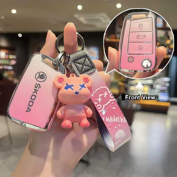 Skoda key cover in pink, featuring a cute bear charm and front view of the key fob, designed for octavia pro, scala, kamiq, a...