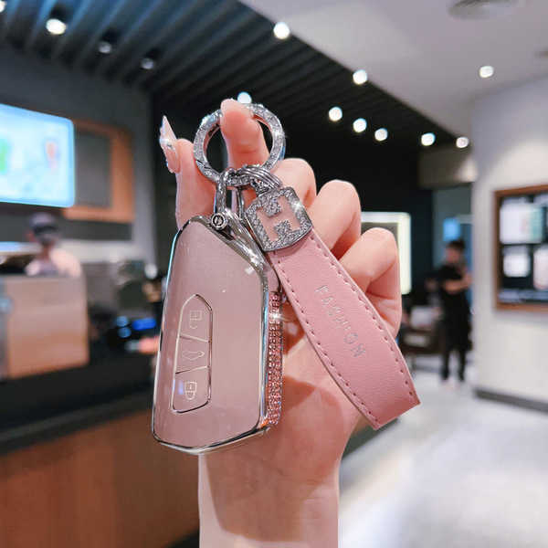 Elegant pink volkswagen key cover for id.3, id.4, golf 8, passat, and cc, featuring a sleek design with a leather strap and s...