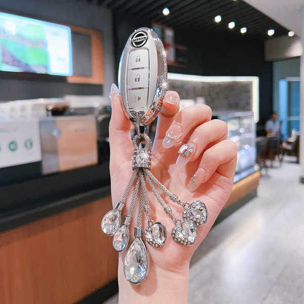 Elegant nissan sylphy key cover with sparkling crystal charms, designed for 14th gen altima, x-trail, and qashqai, showcased ...