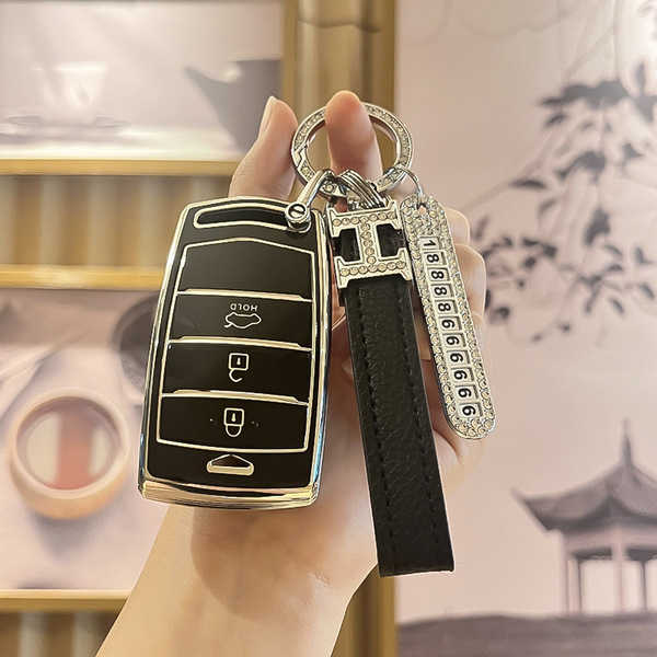 Elegant genesis g90 key cover with premium leather strap and decorative h charm, designed for g80 and g70 models.
