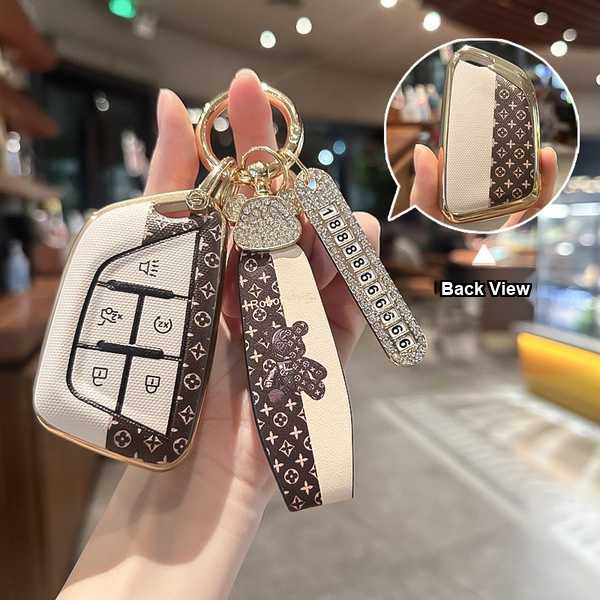 Elegant cadillac key cover for xt6, ct5, xt5, xt4, ct6, xts, atsl, featuring a stylish design with a beaded strap and back vi...