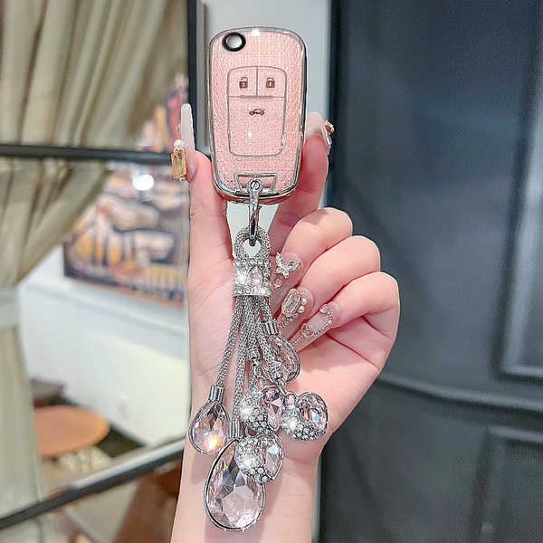Elegant chevrolet key cover for cruze, malibu & trax, featuring a pink textured design and sparkling crystal keychain.