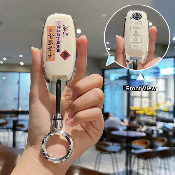 Elegant white nissan key cover with decorative calligraphy, designed for 14th-gen sylphy and 2022–2023 altima, featuring a sl...