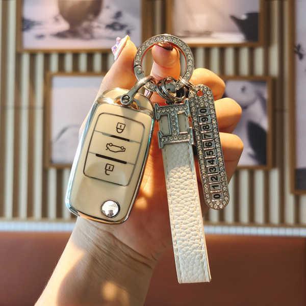 A hand holds a stylish changan ruicheng cc key cover for cs75, cs55, and eado models, featuring a sleek design with a leather...