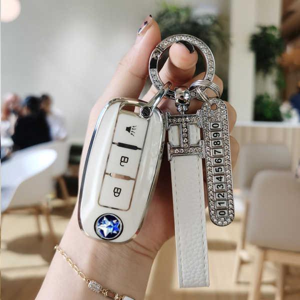 Elegant dongfeng venucia t60 key cover featuring premium leather, a sparkling diamond ring, and a stylish wrist strap for wom...