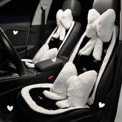 Cozy bow plush car seat cushion with fluffy white accents, perfect for a warm and goddess-style ride.