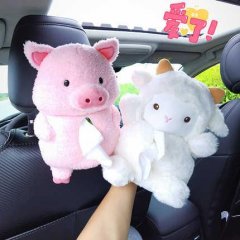 A hand holds a pink pig and white sheep plush tissue box holder in a car, featuring cute cartoon designs for stylish storage.