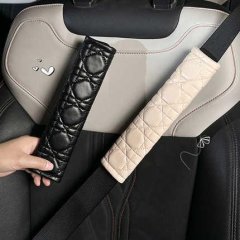 Leather seat belt shoulder protector in black and beige, offering anti-chafe comfort and stylish design for car interiors.
