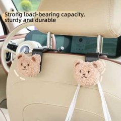 Cute bear car hooks with strong load-bearing capacity, securely attached to car seat backs for added storage and convenience.