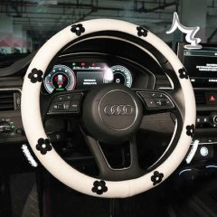 Elegant daisy steering wheel cover featuring black floral designs on a white cotton-linen blend, providing a non-slip grip fo...