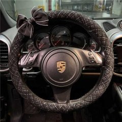 Elegant chanel-style steering wheel cover with a bow, crafted from cotton linen, adorning a porsche dashboard for a luxurious...