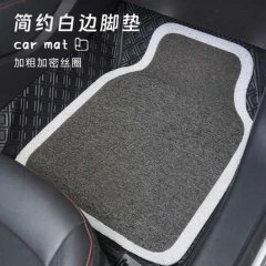 Gray all-season car floor mat with white border and silk loop texture, designed for anti-slip performance and easy cleaning.