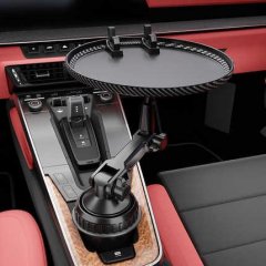 Car-mounted round cup holder & phone tray: sleek black design with adjustable arm, perfect for modern car interiors.