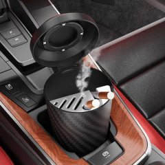 Car-specific portable ashtray with lid, featuring a sleek carbon fiber design and built-in ventilation, perfect for on-the-go...