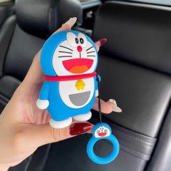 A hand holds a blue doraemon keychain cover with a red collar and bell, designed for byd, chery, geely, roewe, and hyundai ca...