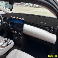 Interior view of a gac aion ut dashboard featuring a black sun shade mat with aion branding, enhancing both style and functio...
