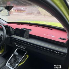 Close-up of a wuling starracer dashboard featuring a red and black design with yellow stitching, showcasing the cars modern i...