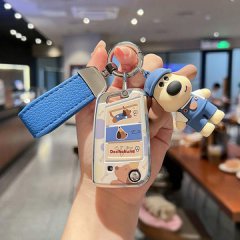 A hand holds a volkswagen car key cover featuring a cute dachshund design, complete with a blue leather strap and a matching ...