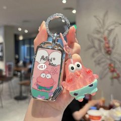 A hand holds a stylish key cover featuring patrick star from spongebob, paired with a matching translucent charm, designed fo...