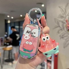 A hand holds a vibrant key cover featuring patrick star from spongebob, paired with a matching translucent charm. the key she...
